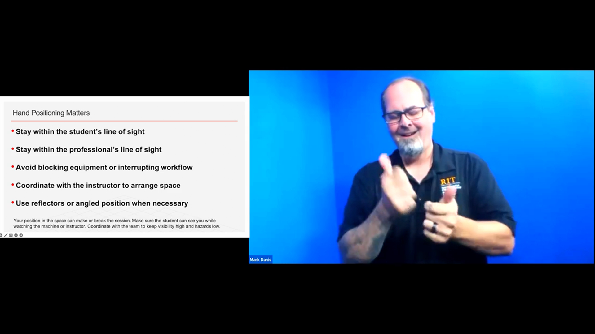 A presentation slide titled "Hand Positioning Matters" is displayed on the left, listing four key guidelines for sign language interpreters, such as staying within the line of sight and avoiding the blocking of equipment. On the right, an interpreter identified as Mark Davis, wearing an RIT-branded shirt, is actively signing against a bright blue background. The slide's footnote emphasizes the importance of coordinating with the team to ensure high visibility and low hazards when interpreting near machinery.