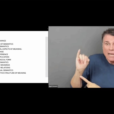 The slide discusses "SEMANTICS" and lists subbranches including "FORMAL SEMANTICS" and "CONCEPTUAL SEMANTICS." On the right, a man in a navy shirt is signing, pointing his right index finger upwards while his left hand is pointing forward and down.