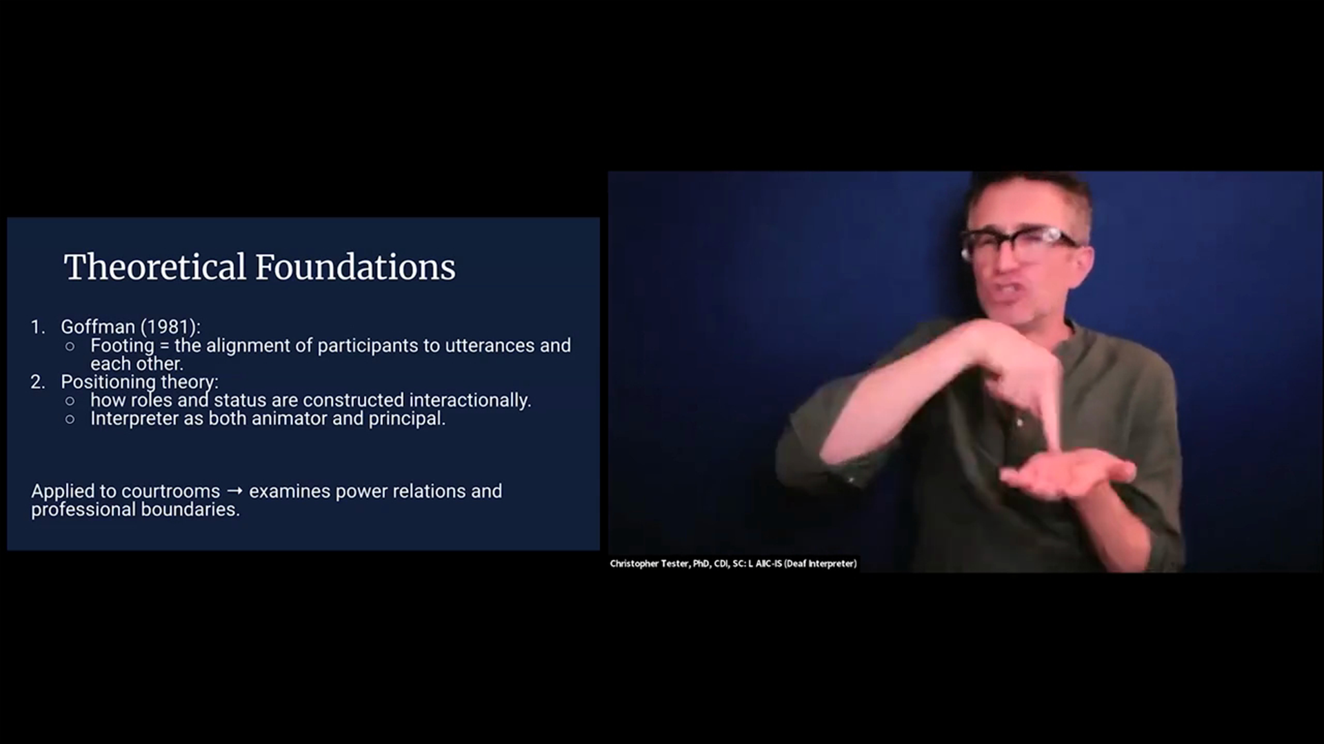 The slide is titled "Theoretical Foundations" and lists Goffman’s (1981) "Footing" and "Positioning theory," applied to courtroom power relations. On the right, a man in glasses and a dark blue shirt is signing, holding his right hand over his open left palm.
