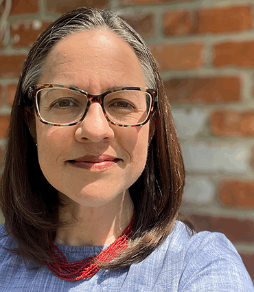 Headshot of Leslie Pertz, LCSW, PMH-C, NIC, RYT-200.