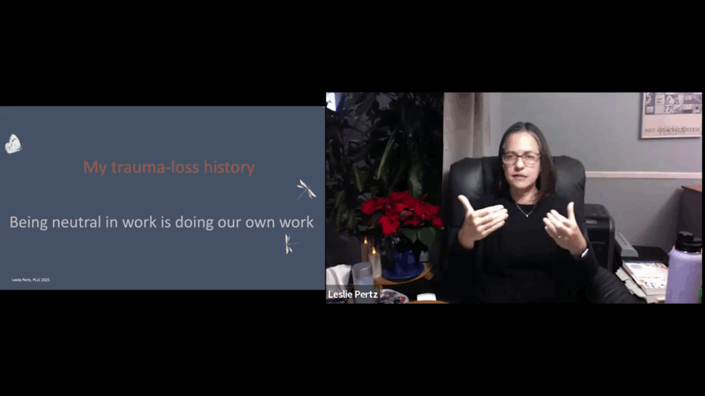 A split-screen layout shows a dark grey slide on the left titled "My trauma-loss history" with the phrase "Being neutral in work is doing our own work". On the right, presenter Leslie Pertz is signing.