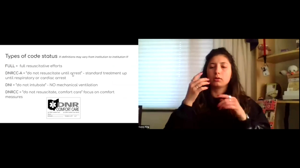 A split-screen screenshot from a virtual presentation. On the left side, a presentation slide is titled "Types of code status" with a note stating "definitions may vary from institution to institution." The slide outlines four categories: FULL (full resuscitative efforts), DNRCC-A ("do not resuscitate until arrest" - standard treatment up until respiratory or cardiac arrest), DNI ("do not intubate" - NO mechanical ventilation), and DNRCC ("do not resuscitate, comfort care" focus on comfort measures). A small graphic of an official Ohio "DNR COMFORT CARE" form is at the bottom of the slide. On the right side, a video window shows a presenter, identified by a name tag as Casey King, a woman with long dark hair wearing a dark shirt, mid-gesture while presenting the material.