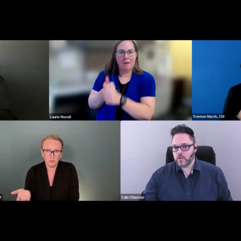 A screenshot of a virtual panel discussion shows five participants arranged in a grid layout against solid or office backgrounds. The top row features moderator Corey Axelrod, panelist Laurie Monell (who is actively signing), and panelist Trenton Marsh, while the bottom row displays ASL/English interpreters Aaryn Adams and Cain Chiasson.